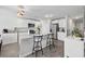 Bright kitchen features white cabinets, modern appliances, an island with seating, and updated lighting fixtures at 417 Spruce Pine Way, Conway, SC 29526