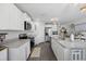 Modern, well-lit kitchen with white cabinetry, stainless steel appliances, and spacious island at 417 Spruce Pine Way, Conway, SC 29526