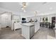 Bright kitchen with stainless steel appliances, island with sink, and open floor plan to dining and living areas at 417 Spruce Pine Way, Conway, SC 29526