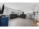 Bright and airy living room with open floor plan, modern furniture, and eat-in kitchen bar at 417 Spruce Pine Way, Conway, SC 29526