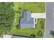 Aerial view of house showcasing roof, driveway, landscaping, and surrounding greenery at 4536 Fringetree Dr., Murrells Inlet, SC 29576