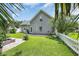 Grassy backyard with mature landscaping, patio and a white picket fence at 4536 Fringetree Dr., Murrells Inlet, SC 29576