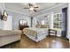 Spacious bedroom with a ceiling fan, natural light, and hardwood floors at 4536 Fringetree Dr., Murrells Inlet, SC 29576