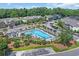 Aerial view of the community pool surrounded by lush landscaping and seating areas at 4536 Fringetree Dr., Murrells Inlet, SC 29576