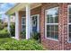 Close-up view of the brick front porch with a welcoming blue door and decorative wreath at 4536 Fringetree Dr., Murrells Inlet, SC 29576