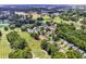 Aerial view of the golf course and neighborhood with a pond and lush green landscaping at 4650 Greenbriar Dr. # A5, Little River, SC 29566