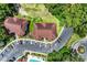 Aerial view of community showing building roofs, parking, community pool, and mature trees at 4650 Greenbriar Dr. # A5, Little River, SC 29566