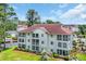 Aerial view of a condo building surrounded by lush greenery, showcasing a serene and picturesque community at 4650 Greenbriar Dr. # A5, Little River, SC 29566