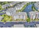 Expansive aerial view of condo community with lake, fountain, manicured lawns and abundant parking spaces at 4821 Luster Leaf Circle # 202, Myrtle Beach, SC 29577