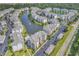 Aerial shot showcasing a condo community, including a pond, swimming pool, parking, and lush green landscaping at 4821 Luster Leaf Circle # 202, Myrtle Beach, SC 29577