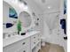 Bright bathroom features a double vanity, shower with tub, coastal decor, and round mirror at 4821 Luster Leaf Circle # 202, Myrtle Beach, SC 29577