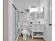 Bright bathroom featuring a modern vanity, round mirror, frosted glass shower, and coastal-themed decor at 4821 Luster Leaf Circle # 202, Myrtle Beach, SC 29577