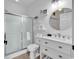 Bright bathroom features a modern vanity, round mirror, frosted glass shower, and coastal-themed decor at 4821 Luster Leaf Circle # 202, Myrtle Beach, SC 29577