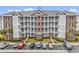 Condo building featuring multiple balconies, well-maintained landscaping and convenient parking, creating a welcoming atmosphere at 4821 Luster Leaf Circle # 202, Myrtle Beach, SC 29577