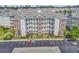 Exterior of the condo building featuring multiple stories, private balconies, and well-maintained landscaping with parking at 4821 Luster Leaf Circle # 202, Myrtle Beach, SC 29577