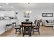 Dining room with modern chandelier, wood floors, and white walls offers a welcoming space for meals at 4821 Luster Leaf Circle # 202, Myrtle Beach, SC 29577