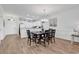 Open dining room featuring wood floors, chandelier, and kitchen view at 4821 Luster Leaf Circle # 202, Myrtle Beach, SC 29577