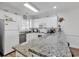 Kitchen showcases granite countertops, white cabinetry, and modern stainless steel appliances at 4821 Luster Leaf Circle # 202, Myrtle Beach, SC 29577
