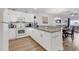 Kitchen featuring white cabinetry, granite countertops, and modern appliances with seamless flow into the dining area at 4821 Luster Leaf Circle # 202, Myrtle Beach, SC 29577