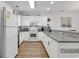 Bright kitchen features white cabinetry, granite countertops, and stainless steel appliances at 4821 Luster Leaf Circle # 202, Myrtle Beach, SC 29577