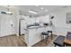 Bright kitchen with white cabinets, a bar counter with seating, and stainless steel appliances at 4821 Luster Leaf Circle # 202, Myrtle Beach, SC 29577