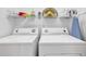 Laundry room featuring a washer, dryer, shelving, and decor at 4821 Luster Leaf Circle # 202, Myrtle Beach, SC 29577