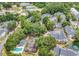 Aerial view of the community showcasing its layout, green spaces, pool, tennis court and surrounding neighborhood at 4840 Moss Creek Loop # 31, Murrells Inlet, SC 29576