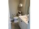 Well-lit bathroom with white vanity, commode, and towel racks with neatly stacked towels at 4840 Moss Creek Loop # 31, Murrells Inlet, SC 29576