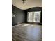 Open bedroom with expansive hardwood floors and ample light from the large window with shutters at 4840 Moss Creek Loop # 31, Murrells Inlet, SC 29576