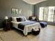Spacious bedroom with wood-look floors, decorative art, and large windows with wood shutters at 4840 Moss Creek Loop # 31, Murrells Inlet, SC 29576