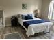 Comfortable bedroom with warm lighting, wood flooring, and a cozy bed with stylish décor at 4840 Moss Creek Loop # 31, Murrells Inlet, SC 29576