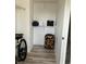 A modest closet with hardwood flooring, storage shelves, and personal luggage at 4840 Moss Creek Loop # 31, Murrells Inlet, SC 29576