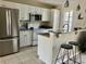 Bright kitchen featuring stainless steel appliances, white cabinets, and a breakfast bar at 4840 Moss Creek Loop # 31, Murrells Inlet, SC 29576