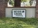 Community sign for Moss Creek Townhouses, surrounded by lush greenery, creating a welcoming entrance at 4840 Moss Creek Loop # 31, Murrells Inlet, SC 29576