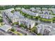 Aerial view of the condo community with a lake, fountain, mature trees, and ample parking at 4887 Luster Leaf Circle # 104, Myrtle Beach, SC 29572