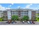 Attractive condo building with balconies, brick accents, and well-maintained landscaping and convenient parking at 4887 Luster Leaf Circle # 104, Myrtle Beach, SC 29572