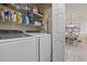 Functional laundry room with a side-by-side washer and dryer and ample storage shelves at 4887 Luster Leaf Circle # 104, Myrtle Beach, SC 29572