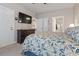 Comfortable bedroom featuring a large dresser, TV, and a glimpse into the bathroom at 4887 Luster Leaf Circle # 104, Myrtle Beach, SC 29572