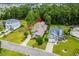 Stunning aerial view showcasing the home's location surrounded by lush greenery and a serene lake at 496 Starlit Way, Myrtle Beach, SC 29579