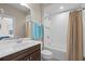 Bright bathroom featuring a shower over tub and vanity with framed mirror and fixtures at 496 Starlit Way, Myrtle Beach, SC 29579
