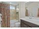 Bathroom featuring shower-tub combination with tile surround, colorful shower curtain and vanity at 496 Starlit Way, Myrtle Beach, SC 29579