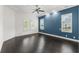 Serene bedroom with dark wood floors, three windows and a splash of color at 496 Starlit Way, Myrtle Beach, SC 29579
