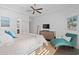 Bright bedroom boasts a ceiling fan, flat screen television, and sitting area with artwork at 496 Starlit Way, Myrtle Beach, SC 29579