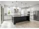 Bright, modern kitchen with white cabinets, stainless steel appliances, and a large center island at 496 Starlit Way, Myrtle Beach, SC 29579