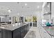 Open-concept kitchen features an island with granite counters and stainless steel appliances, perfect for entertaining at 496 Starlit Way, Myrtle Beach, SC 29579