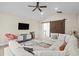 Bright living room featuring a large sectional, ceiling fan, and barn door at 496 Starlit Way, Myrtle Beach, SC 29579