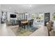 Open-concept living and dining area with modern decor, large windows, and sliding glass doors at 496 Starlit Way, Myrtle Beach, SC 29579