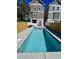 Inviting in-ground swimming pool surrounded by a concrete deck and privacy fence at 505 Chester St 5Th Ave. N, Myrtle Beach, SC 29577