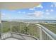 Enjoy ocean views from this balcony, complete with white railings and lush green foliage at 523 S Ocean Blvd. # 305, North Myrtle Beach, SC 29582