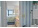 Bathroom view with adjacent bedroom and outdoor vistas beyond the window at 523 S Ocean Blvd. # 305, North Myrtle Beach, SC 29582